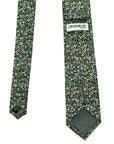 Green cotton tie with intricate floral clover pattern, featuring red and white blossoms, from Crossrow London brand.