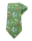 Golden Lily Verdant men's tie featuring a green floral pattern with blue lilies and red blossoms, perfect for formal occasions.