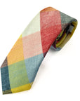 Camden Block tie in cotton with a vibrant ochre, rust, sage, and blue patchwork design.