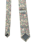 Floral cotton tie with blush, peach, sage, and ivory flowers on a charcoal background by Crossbow London.