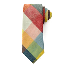 Camden Block tie rolled, showing vibrant patchwork of ochre, rust, sage, blue hues in cotton fabric.