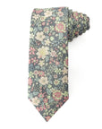 Floral cotton tie with blush, peach, sage, and ivory flowers on a muted charcoal background for smart occasions.
