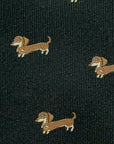 Close-up of black polyester tie featuring a repeating pattern of small brown dachshund dogs.
