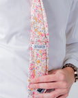 Cotswold Bloom - Tie featuring a floral pattern in pink, orange, and yellow on a beige background.