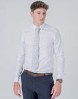 Man wearing a white shirt and floral patterned English Garden Mist - Cotton Tie with blue and lilac flowers.