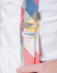 Close-up of Camden Block Check Tie in ochre, rust, sage, and blue hues on a white shirt with a Crossrow London label