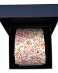 Cotswold Bloom - Tie with pink, orange, and soft yellow floral pattern on a beige background in a navy gift box.