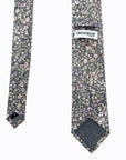 Stone-grey cotton tie with delicate pastel floral pattern in lavender, blush, and sage, perfect for spring events.