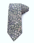 Stone-grey cotton tie with delicate pastel lavender, blush, and sage blossom pattern for weddings and spring events.