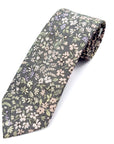 Stone-grey cotton tie with delicate pastel floral pattern in lavender, blush, and sage tones for spring events.