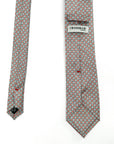 Coral Bloom polyester tie with white floral and coral-red geometric pattern on a subtle grey background.