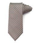 Polyester tie with coral red and white floral geometric pattern on a subtle grey background for stylish wear