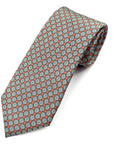 Coral Bloom polyester tie with white floral pattern and coral-red accents on a subtle grey geometric background.