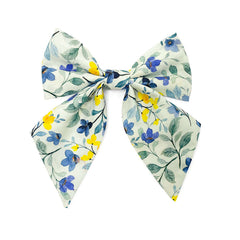Blue Blossoms petite hair bow with blue and yellow flowers on a light green ground, a charming accessory for girls.