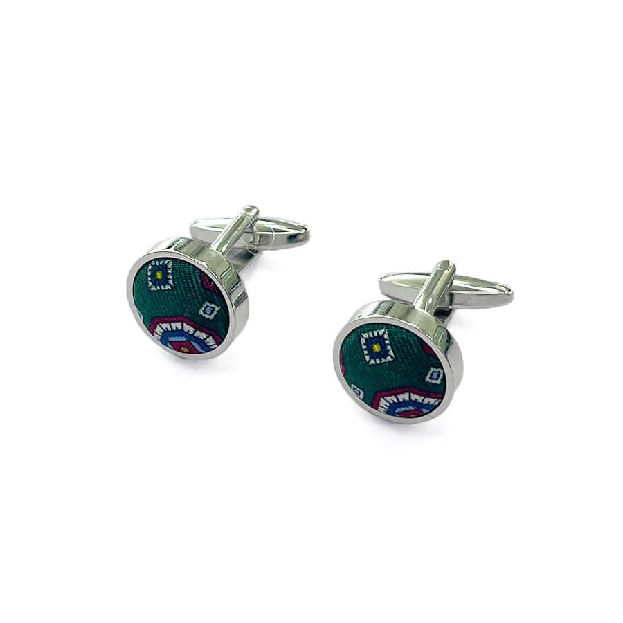 Cufflinks with a striking green and red geometric pattern.