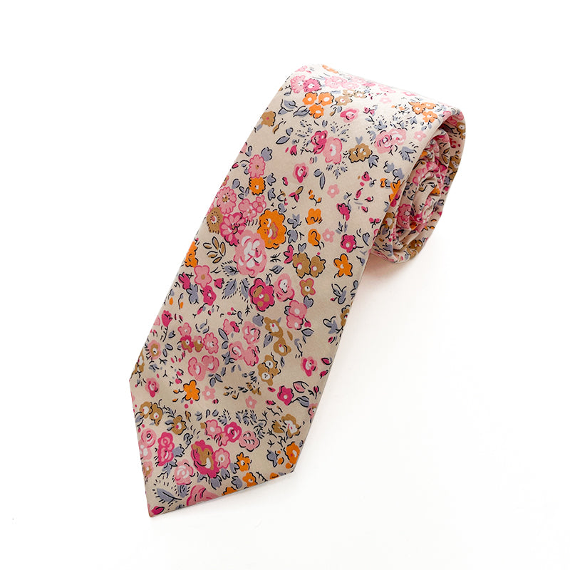 Cotswold Bloom tie with a vibrant floral pattern in pink, orange, and yellow on a beige background