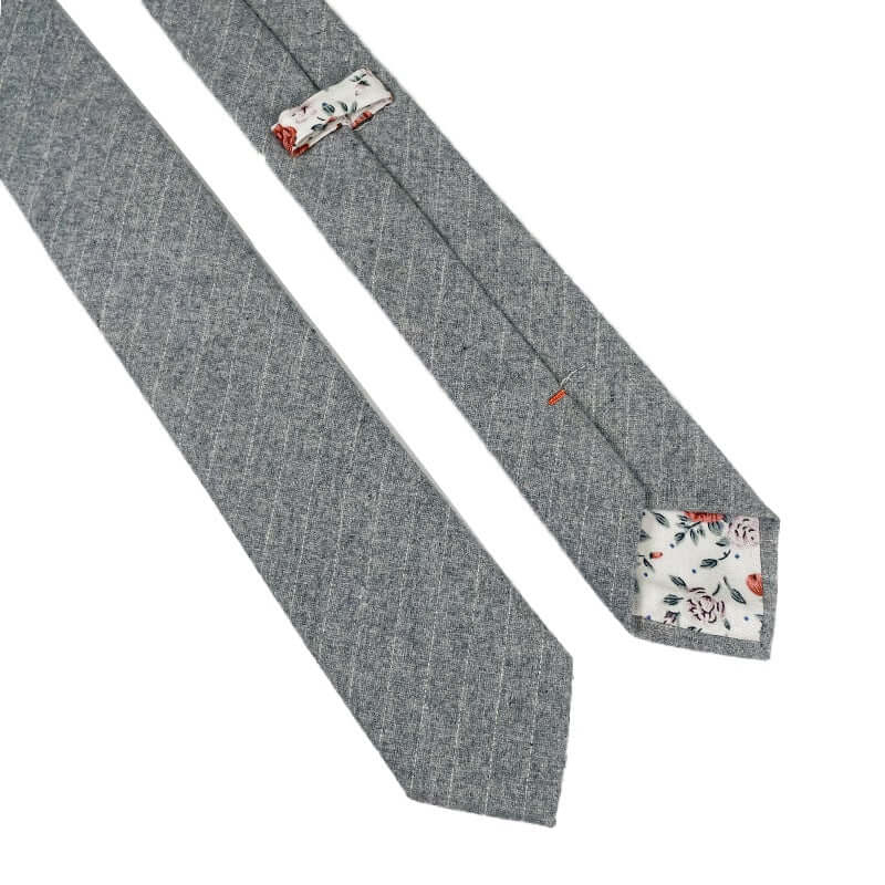 Light grey striped wool tie with floral contrast tip, perfect for adding texture to formal wear.