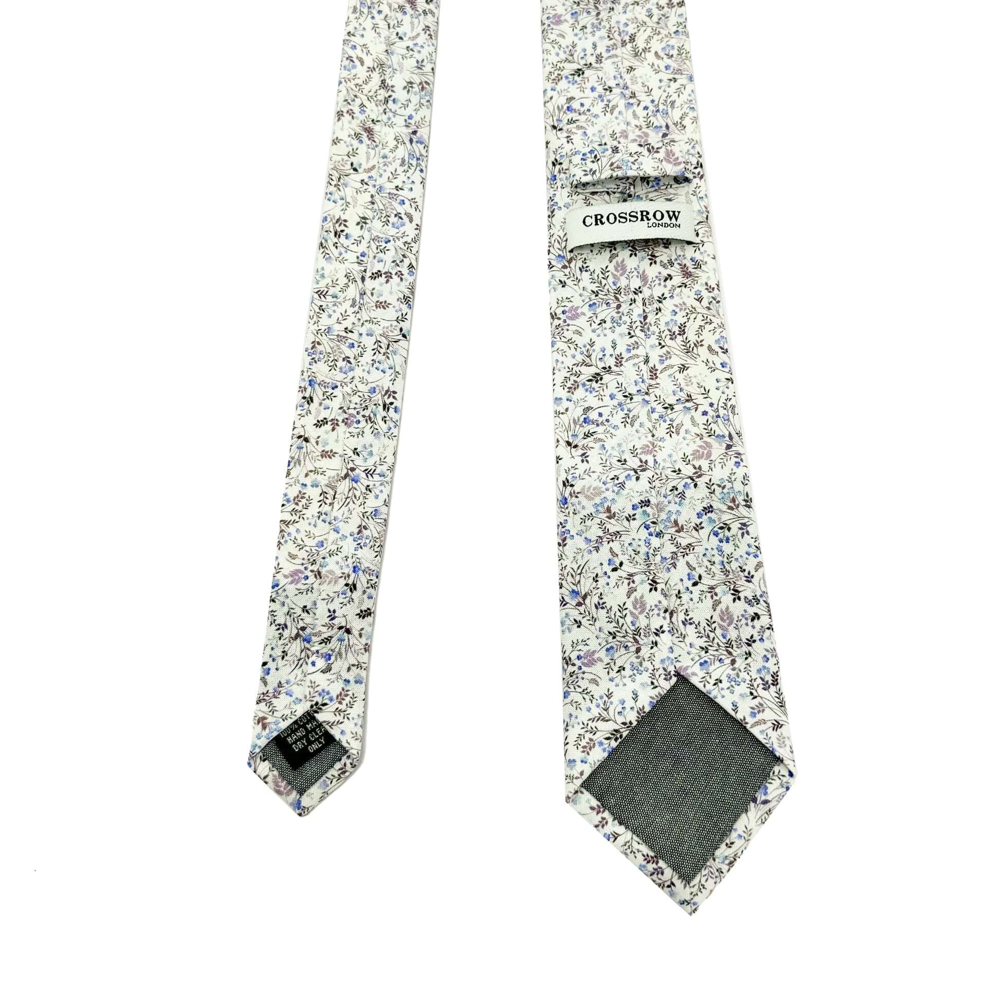 English Garden Mist men&#39;s tie featuring floral design with blue, lilac flowers and neutral tones, perfect for spring and summer.