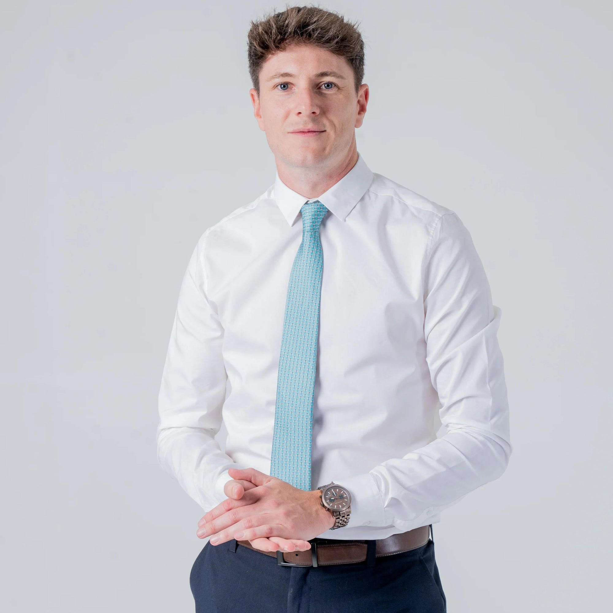 Man wearing a white shirt and Dragonfly Dance - Silk Tie with teal color and subtle dragonfly pattern