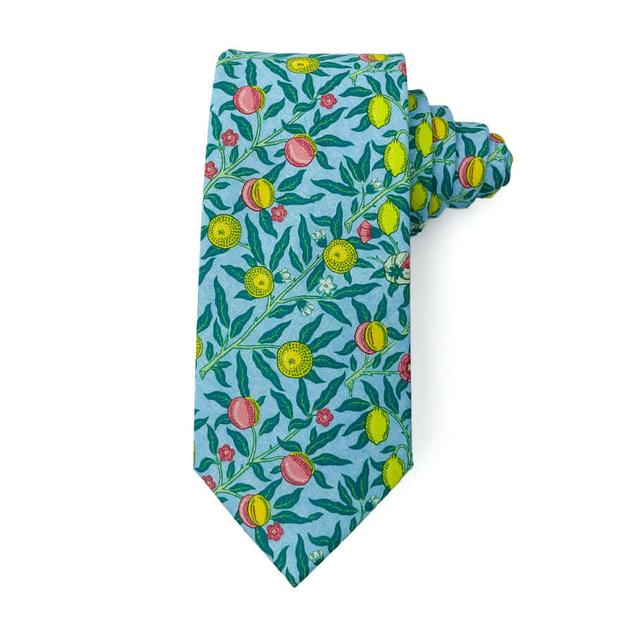 tie with yellow and pink fruit pattern on a blue background, 3 inches wide, 58 inches long, 100% cotton.