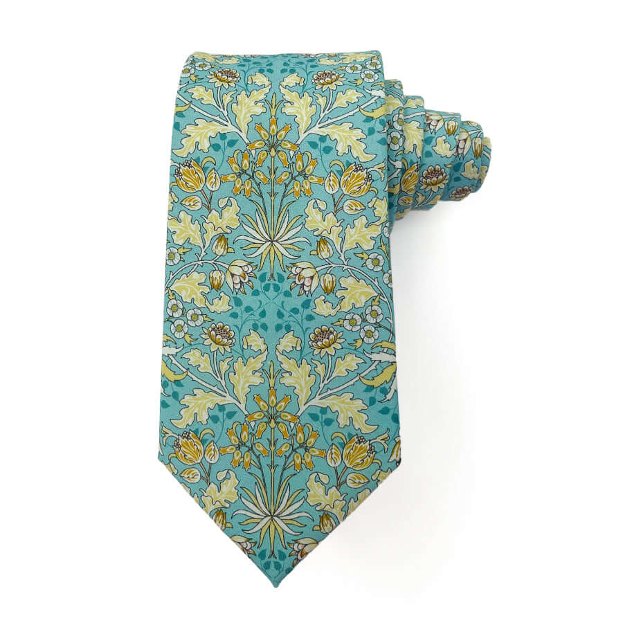 William Morris Wandle Meadow tie with blue and yellow floral pattern, 3 inches wide, 58 inches long, 100% cotton.